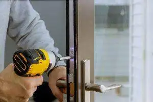 locksmith service technician working on door lock